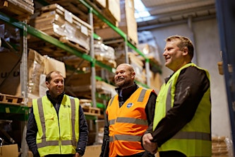 Rothbury Insurance team members in a warehouse.