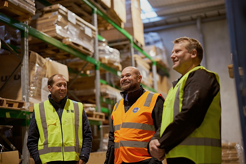 Rothbury Insurance team members in a warehouse.